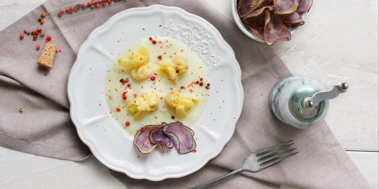Perline con Parmigiano Reggiano DOP su crema di patate ed emmenthal con chips di patate viola